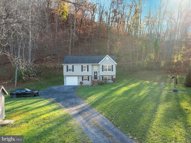 bi-level home featuring a garage and a front yard