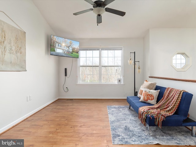 living area featuring ceiling fan and light hardwood / wood-style flooring