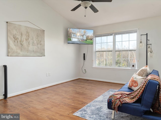 sitting room with ceiling fan and light wood-type flooring