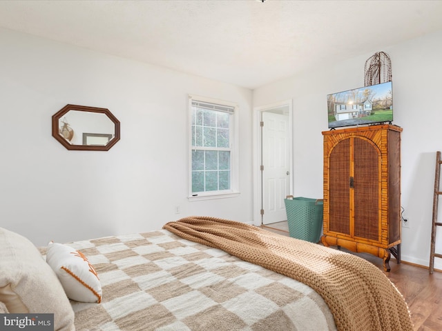 bedroom with wood-type flooring