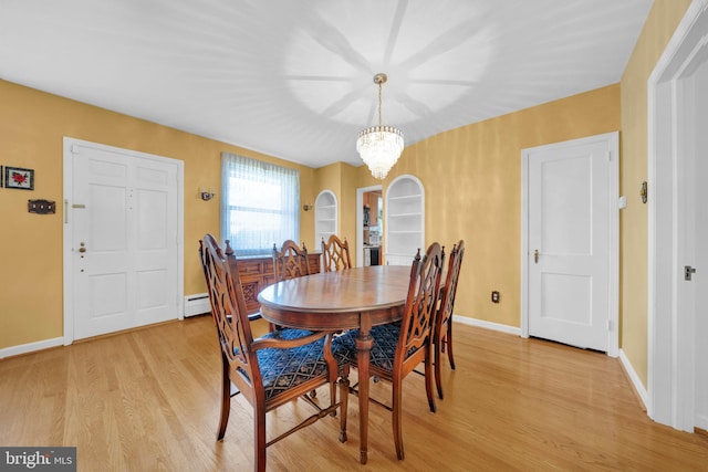 dining space with a chandelier, light hardwood / wood-style flooring, and baseboard heating