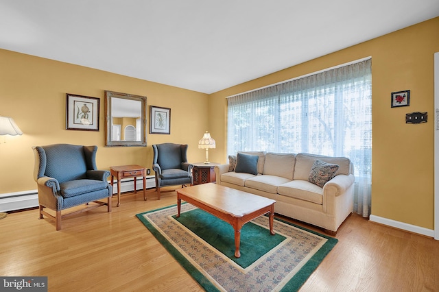 living room with a baseboard radiator and hardwood / wood-style flooring