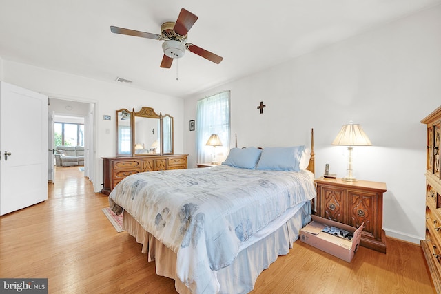 bedroom with light hardwood / wood-style floors and ceiling fan