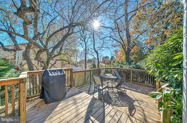 wooden terrace featuring a grill