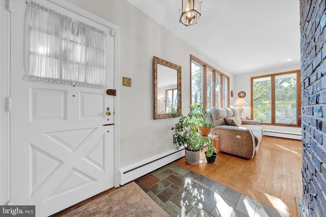 entrance foyer with hardwood / wood-style floors and baseboard heating