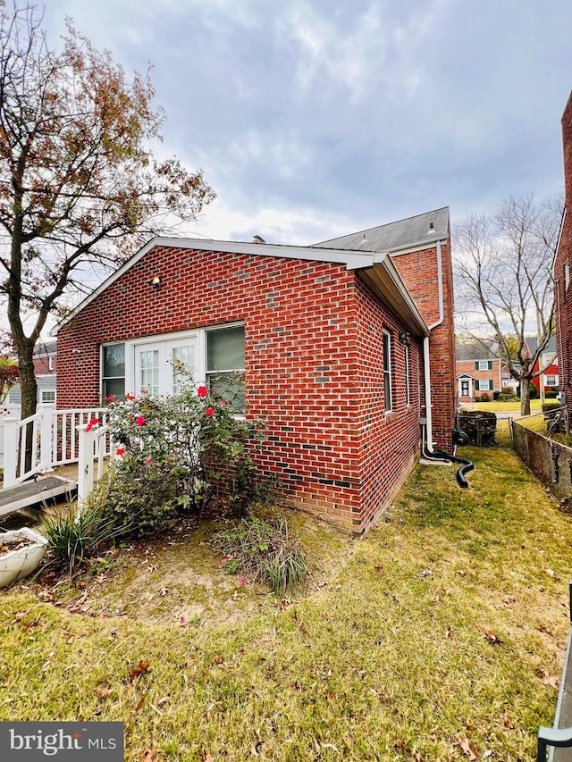 view of property exterior with a lawn