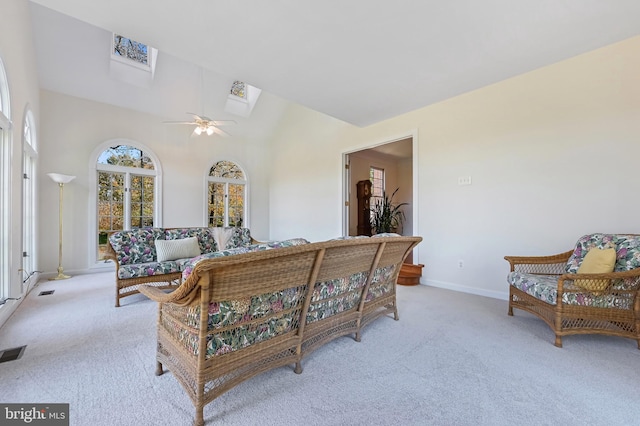 living room with light carpet, high vaulted ceiling, and ceiling fan