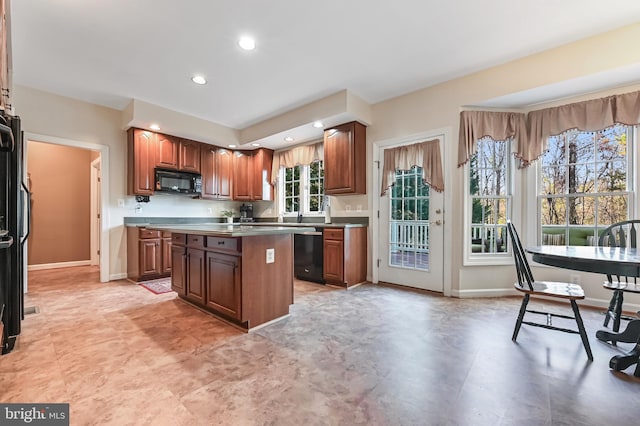 kitchen with a center island, a healthy amount of sunlight, and black appliances