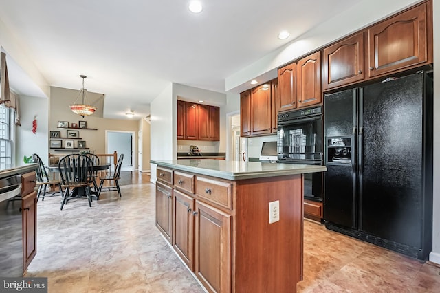 kitchen with black appliances, decorative light fixtures, and a kitchen island