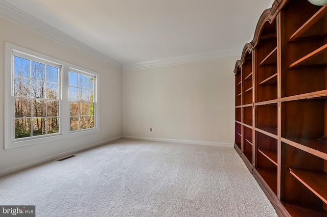 carpeted spare room featuring ornamental molding