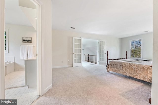 unfurnished bedroom with light carpet and french doors