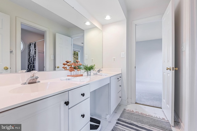 bathroom featuring curtained shower and vanity