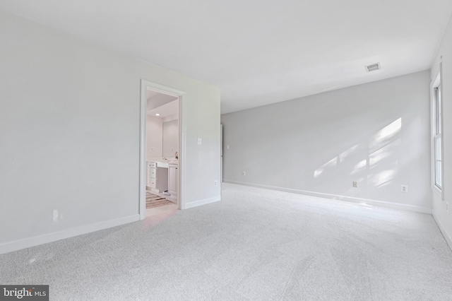 empty room featuring light colored carpet