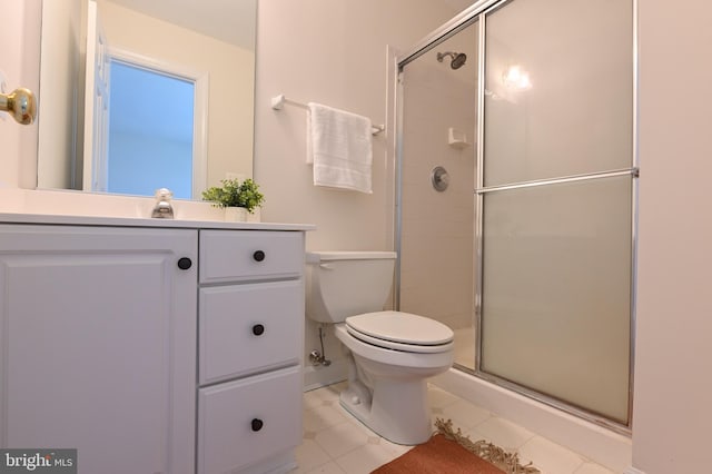 bathroom with vanity, toilet, walk in shower, and tile patterned floors