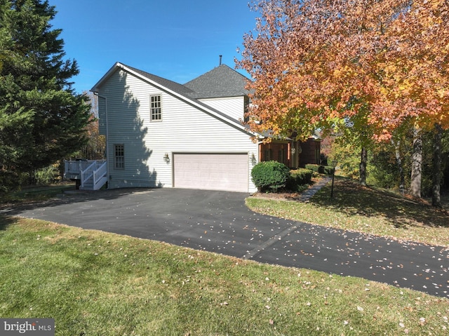 view of front of property with a front yard and a garage