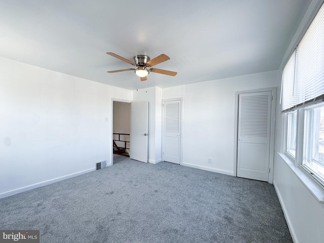 unfurnished bedroom featuring ceiling fan and carpet floors