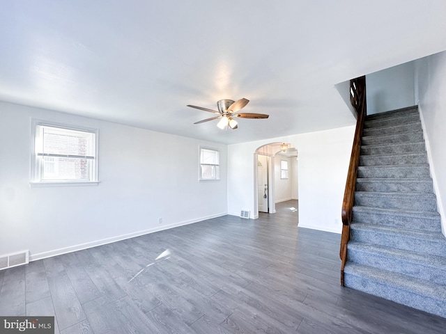 interior space with dark hardwood / wood-style flooring, ceiling fan, and a healthy amount of sunlight