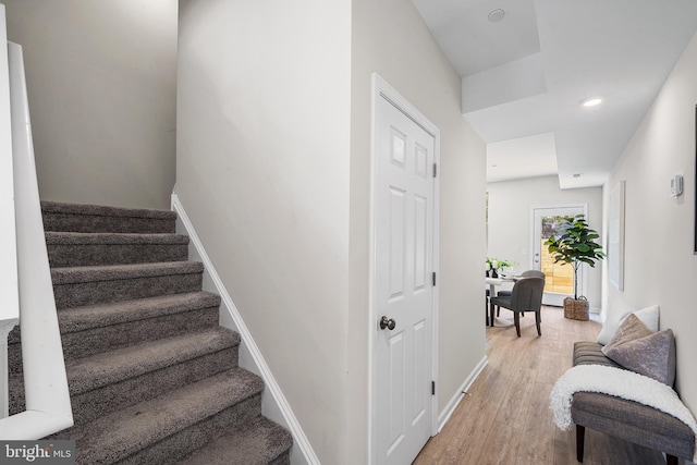 stairs featuring hardwood / wood-style flooring