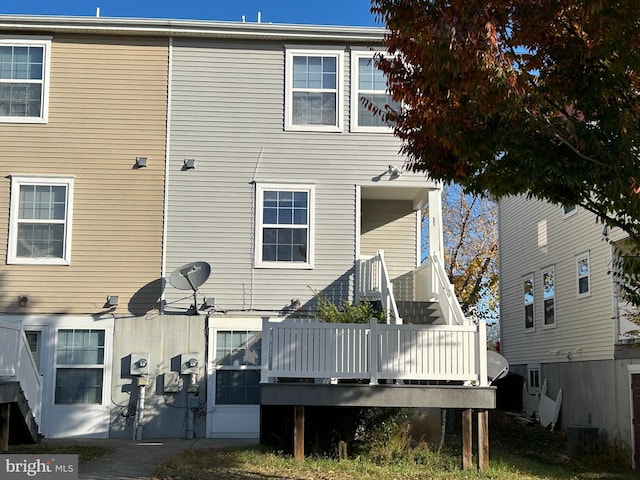 back of property with a wooden deck and central AC unit