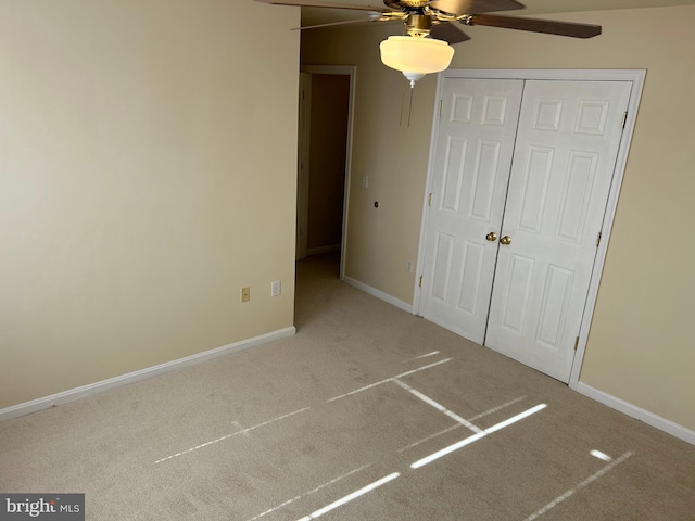 unfurnished bedroom with carpet flooring, a closet, and ceiling fan