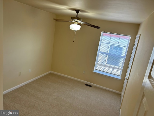 unfurnished room with ceiling fan, light colored carpet, and vaulted ceiling