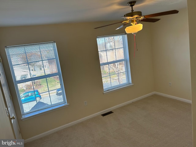 unfurnished room with carpet and ceiling fan