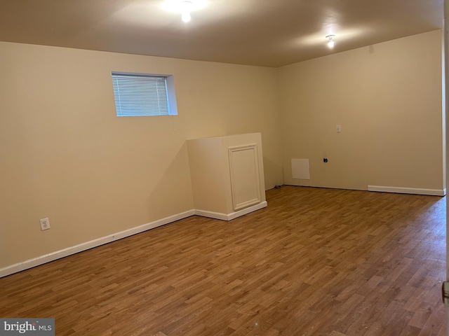 basement with hardwood / wood-style floors