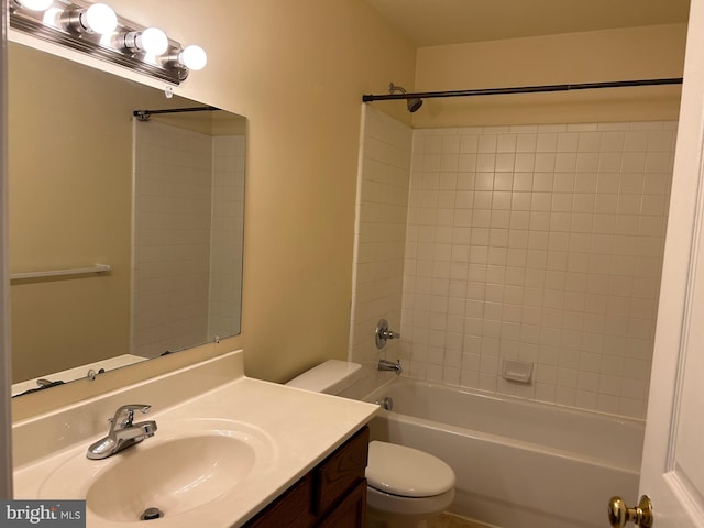 full bathroom with vanity, tiled shower / bath, and toilet