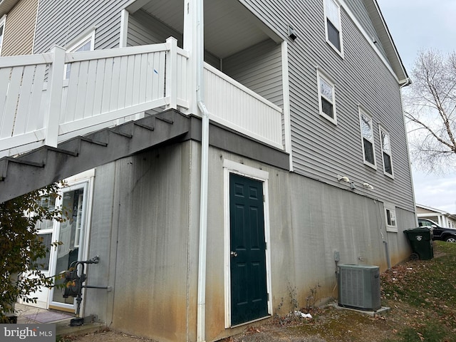 view of property exterior featuring a balcony and central air condition unit