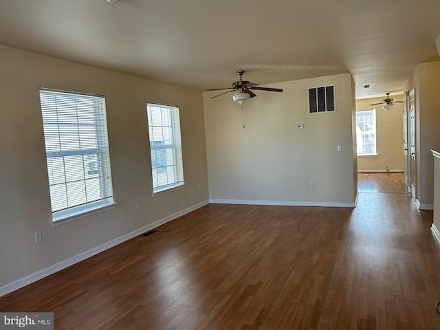 spare room with ceiling fan and dark hardwood / wood-style flooring