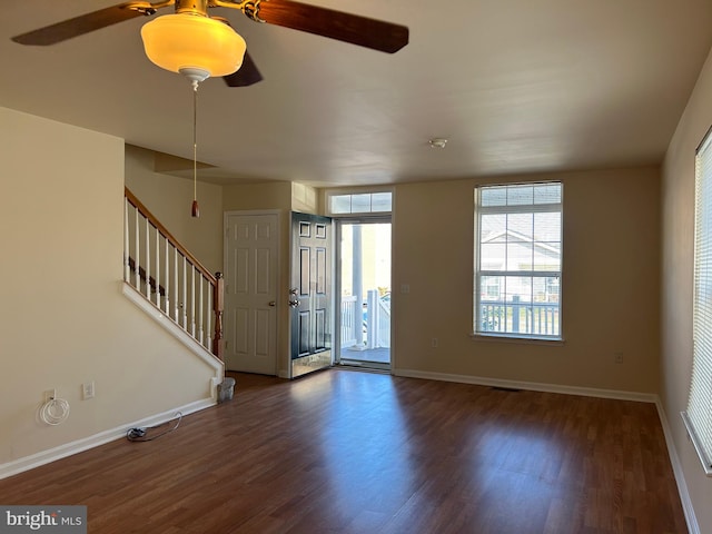 foyer entrance featuring ceiling fan and dark wood-type flooring