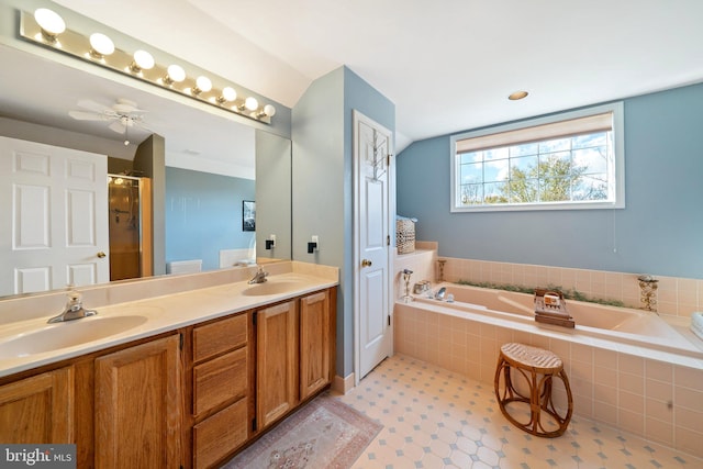 bathroom featuring independent shower and bath, vanity, and ceiling fan