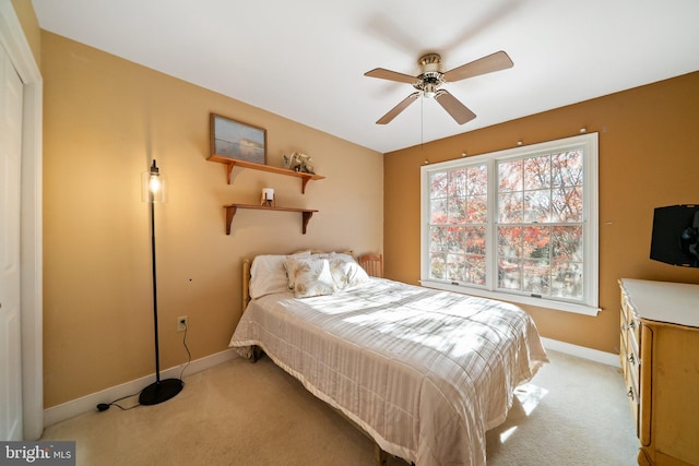 bedroom with ceiling fan and light colored carpet