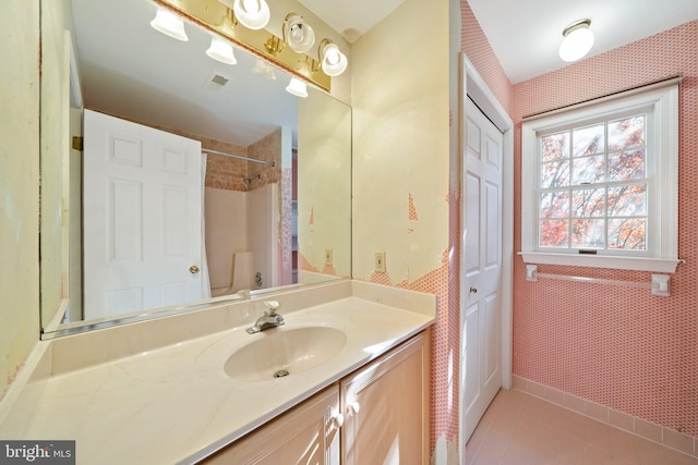 bathroom featuring toilet, vanity, and tile patterned floors