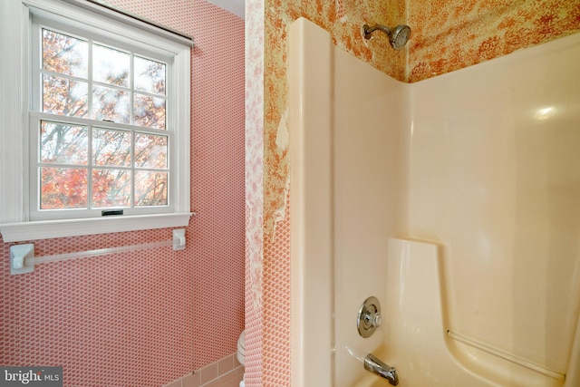 bathroom with shower / bath combo with shower curtain