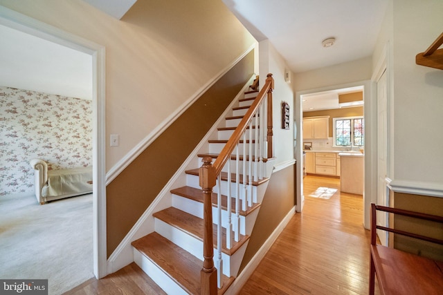 stairs featuring wood-type flooring