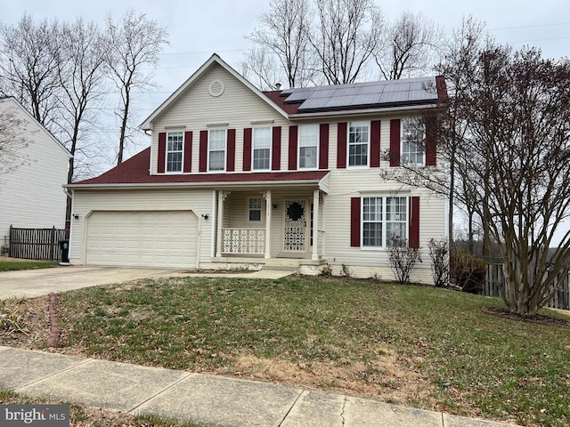 colonial-style house featuring a porch, a front yard, and solar panels