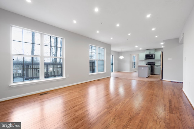 unfurnished living room with light wood-type flooring