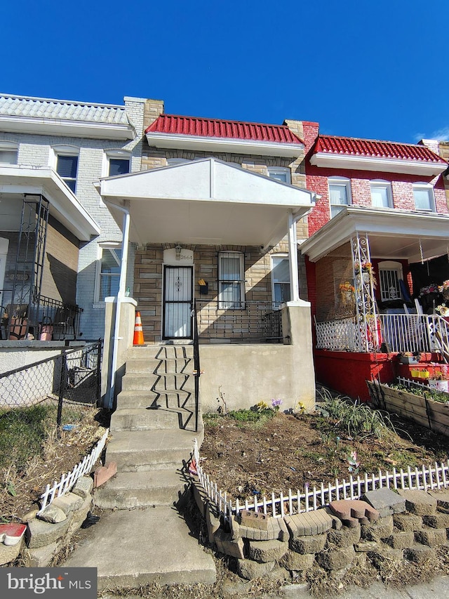 view of front of home featuring brick siding and a porch