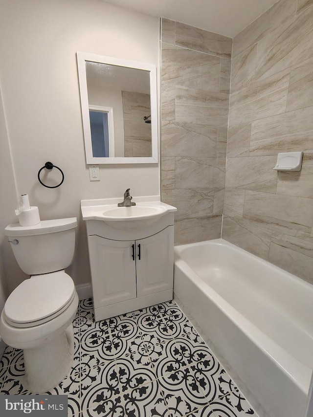 full bath featuring tile patterned flooring, toilet, vanity, and shower / washtub combination