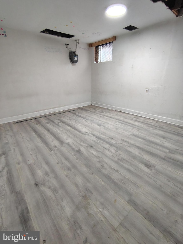 below grade area with baseboards and wood finished floors