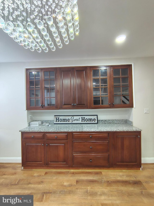 interior details with baseboards and wood finished floors