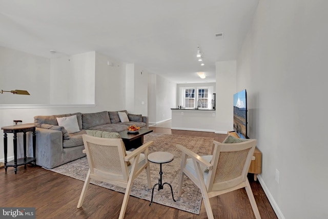 living room featuring dark wood-type flooring