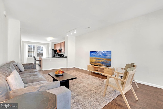 living room featuring hardwood / wood-style floors and track lighting