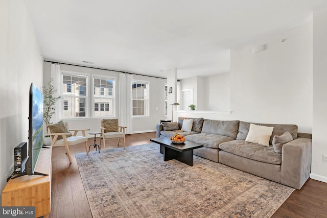 living room with dark hardwood / wood-style flooring