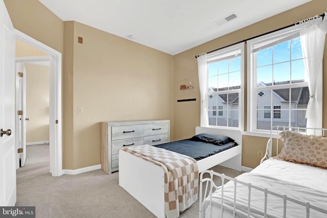 bedroom with light colored carpet