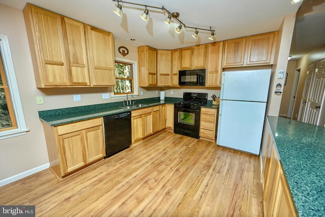 kitchen featuring sink, track lighting, light hardwood / wood-style flooring, and black appliances