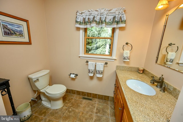 bathroom featuring tile patterned floors, vanity, and toilet