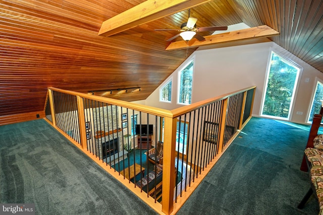 interior space with dark colored carpet, ceiling fan, wooden ceiling, and lofted ceiling