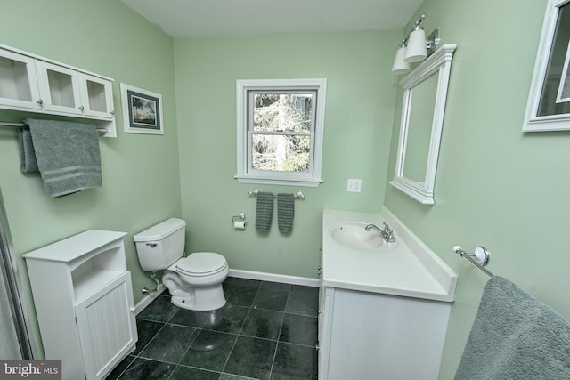 bathroom featuring tile patterned floors, vanity, and toilet